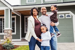 family standing in front of house